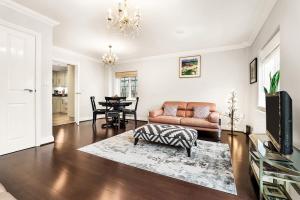 a living room with a couch and a table at Chic 3Bed House & Garden Near Shelford High Street in Trumpington +10 photos