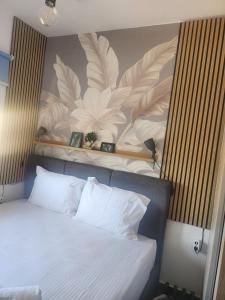 a bedroom with a bed with a flower mural on the wall at Villa Sokrates in Nea Vrasna