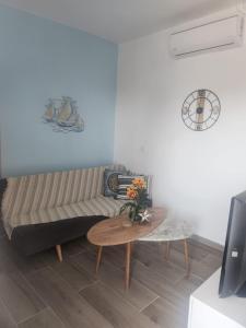 a living room with a couch and a table at Villa Sokrates in Nea Vrasna +18 photos