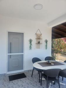 a dining room with a table and chairs at Villa Sokrates in Nea Vrasna