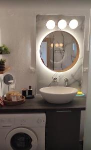 a bathroom with a sink and a mirror at Villa Sokrates in Nea Vrasna