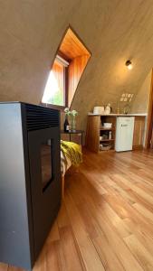 Habitación grande con cocina y suelo de madera. en Casa Redonda, en Golondrinas