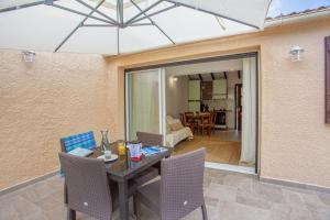 a dining table and chairs in a room with a living room at Casa Noel in Linguizzetta +17 photos