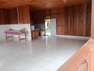 an empty kitchen with a table in a room at Parfray Homestay Raja Ampat in Airborei +12 photos