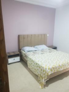 a bedroom with a bed and two night stands at S2 lux jardin carthage in Tunis