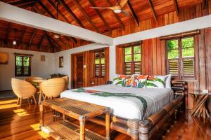 a bedroom with a bed and a table and chairs at Jungle Bay Dominica in Soufrière +48 photos