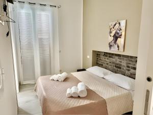 a bedroom with a bed with two towels on it at Casa Lucid'amare Relaxation in Isola delle Femmine