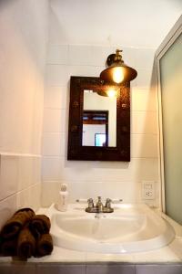 a bathroom with a sink and a mirror at Mini Lofts Ajijic in Ajijic +72 photos