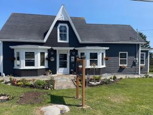 a blue house with a sign in front of it at Route3BnB in Shag Harbour