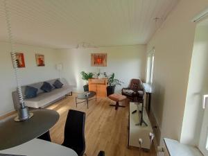 a living room with a couch and a table at Apartment with water views in Fjerritslev