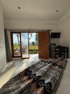 a bedroom with a large bed and a sliding glass door at Rumi Bumi Lovina - A Home For Unhurried Days in Lovina