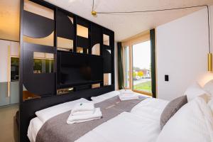 Postel nebo postele na pokoji v ubytování VISIMO Apartments Zurich Airport + 1 fotografie