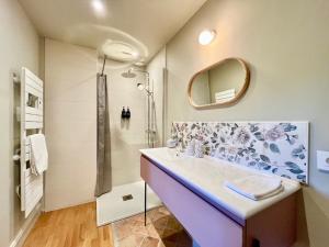 a bathroom with a sink and a shower at T3 Duplex dépendance du Château in Gennes +12 photos