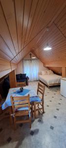 a room with a table and chairs and a bed at Apartment-Koželj in Dobrna