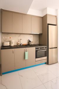 a kitchen with stainless steel appliances and white tile floors at Limassol Centr Apartament in Limassol