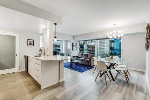 a kitchen and living room with a table and chairs at Newmark Jewel in Seattle