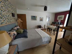 a bedroom with a bed and a table in a room at Gourmandise in Coutances