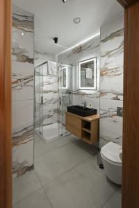 a bathroom with a sink and a toilet at R Zajazd Witnica in Witnica