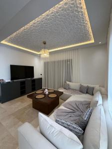 a living room with a couch and a table at Appartement modern a malabata hills in Tangier +4 photos