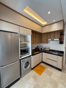 a kitchen with a refrigerator and a washing machine at Appartement modern a malabata hills in Tangier