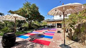eine Reihe bunter Yogamatten auf dem Boden in der Unterkunft Padre Sol Yoga Retreat Center Málaga by AndaraHolidays in Sayalonga + 78 Fotos
