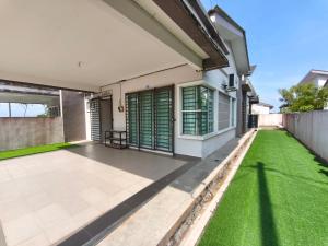 an image of a house with a green lawn at Ana Homestay Moslim only 4 airconds Wi-Fi in Alor Setar