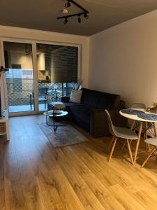 a living room with a couch and a table at Apartament Bajka nad Jeziorem in Nysa