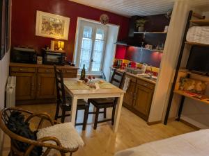 a kitchen with a table and chairs in a room at Gourmandise in Coutances
