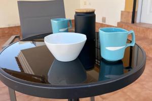 three blue and white vases sitting on a glass table at Sun golf and swimming pool the ideal villa for your holidays! in Vistabella