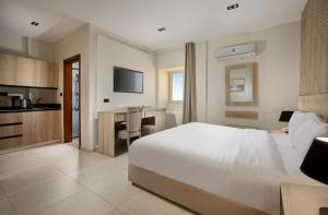 a bedroom with a bed and a desk and a kitchen at Rivana Residence New Cairo - Pool & GYM Access in Cairo