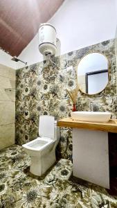 a bathroom with a toilet and a sink and a mirror at Cloud Culture Villa in Baragrān