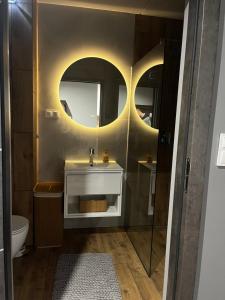 a bathroom with a sink and a mirror at Apartament Bajka nad Jeziorem in Nysa +27 photos