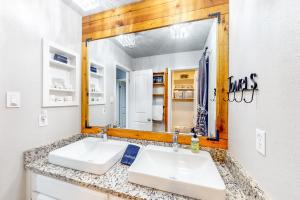 a bathroom with two sinks in front of a mirror at Camp Warnecke Estates Unit B104 in New Braunfels +11 photos