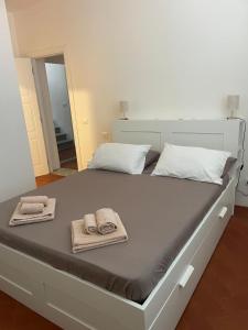 a white bed with towels and towels on it at Affittacamere Clara in Lucca +20 photos