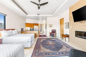 a living room with a bed and a fireplace at Red Rock Suite in Santa Clara