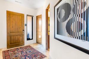 a hallway with a door and a rug at Red Rock Suite in Santa Clara