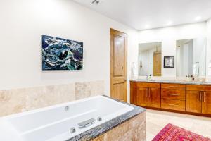 a large bathroom with a tub and a sink at Red Rock Suite in Santa Clara +9 photos
