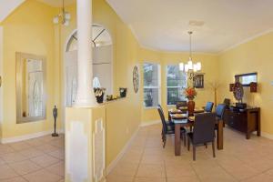 a dining room and living room with a table and chairs at Villa Savona in Cape Coral