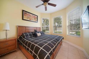 a bedroom with a bed and a ceiling fan at Villa Savona in Cape Coral +32 photos