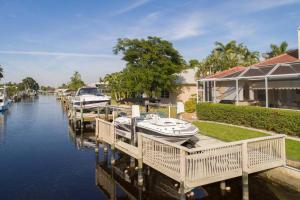 a marina with boats docked next to a house at Villa Savona in Cape Coral