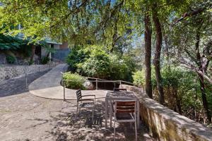 two chairs sitting at a table under a tree at The Village at Gruene in New Braunfels
