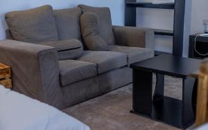 a living room with a couch and a table at Sinty's furnished homes in Narok