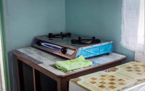 a stove top oven sitting on top of a counter at Sinty's furnished homes in Narok