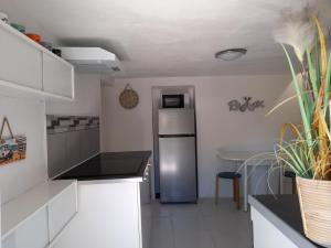 a kitchen with a stainless steel refrigerator in it at Maison avec jacuzzi et jardin privé, proche plage in Le Pradet