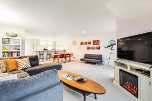 a living room with a couch and a fireplace at Jewel by the Sea in Westport