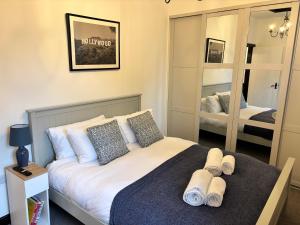 a bedroom with a bed and a large mirror at Luxury Cottage Settle in Settle