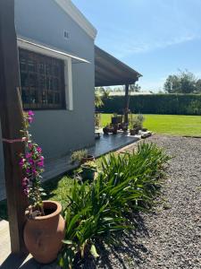 a house with a bunch of plants in front of it at Quinta La Berna in Etchegoyen