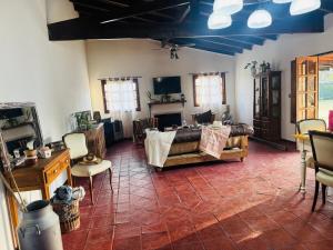 a living room with a table and chairs at Quinta La Berna in Etchegoyen