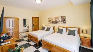 a hotel room with two beds and a tv at Soul History Hotel Phu Quoc in Phu Quoc +82 photos