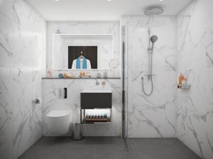 een witte badkamer met een wastafel en een douche bij Hotel Indigo Torquay, By IHG in Torquay